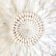 Soft white Feather and shell wall juju art. Natural wall hanging for a Coastal boho, Bohemian Home aesthetic. Wall decor art with soft textures and shell design in the center. Large unique wall decor.
White Feather Juju. 