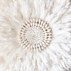 Soft white Feather and shell wall juju art. Natural wall hanging for a Coastal boho, Bohemian Home aesthetic. Wall decor art with soft textures and shell design in the center. Large unique wall decor.
White Feather Juju. 