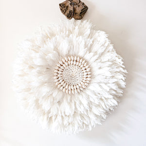Soft white Feather and shell wall juju art. Natural wall hanging for a Coastal boho, Bohemian Home aesthetic. Wall decor art with soft textures and shell design in the center. Large unique wall decor.
White Feather Juju. 