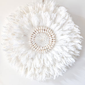 Soft white Feather and shell wall juju art. Natural wall hanging for a Coastal boho, Bohemian Home aesthetic. Wall decor art with soft textures and shell design in the center. Large unique wall decor.
White Feather Juju. 