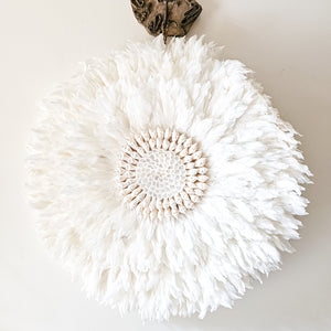 Soft white Feather and shell wall juju art. Natural wall hanging for a Coastal boho, Bohemian Home aesthetic. Wall decor art with soft textures and shell design in the center. Large unique wall decor.
White Feather Juju. 