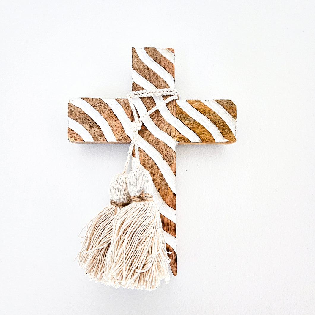 Mango wood hand carved cross with intricate wave design. Handcrafted wall decor, wall cross with cotton tassels 