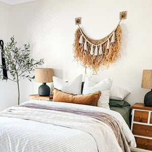 Natural straw, Raffia hanging with wood beaded garland of cotton tassels. Coastal Bohemain, boho inspired home. Coastal boho interior style wall hangings. Natural wall art. Natural earrhy organic materials. 