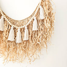 Natural straw, Raffia hanging with wood beaded garland of cotton tassels. Coastal Bohemain, boho inspired home. Coastal boho interior style wall hangings. Natural wall art. Natural earrhy organic materials. 