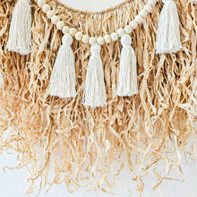Natural straw, Raffia hanging with wood beaded garland of cotton tassels. Coastal Bohemain, boho inspired home. Coastal boho interior style wall hangings. Natural wall art. Natural earrhy organic materials. 