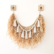 Natural straw, Raffia hanging with wood beaded garland of cotton tassels. Coastal Bohemain, boho inspired home. Coastal boho interior style wall hangings. Natural wall art. Natural earthy organic materials. 